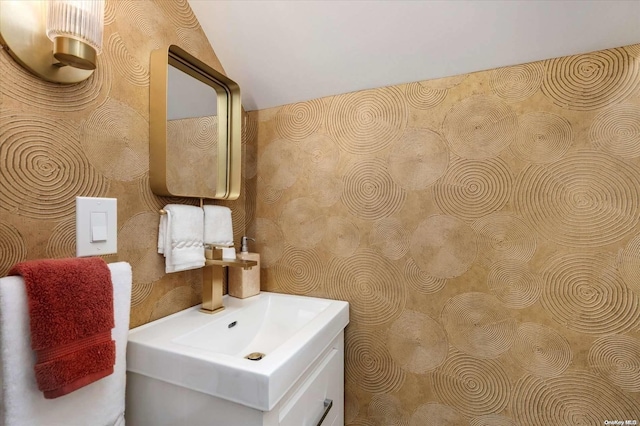 bathroom featuring vanity and vaulted ceiling