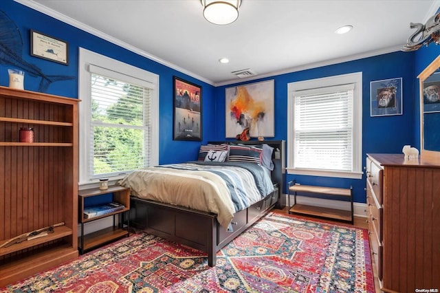 bedroom featuring hardwood / wood-style flooring and ornamental molding