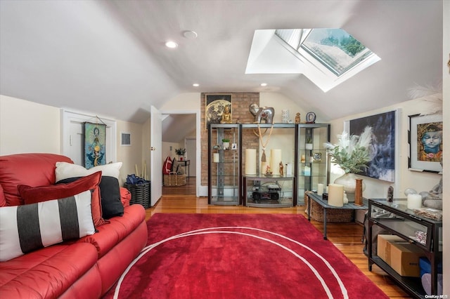 living room with vaulted ceiling with skylight and hardwood / wood-style floors