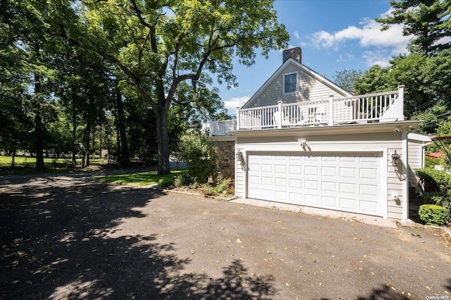 exterior space featuring a balcony and a garage