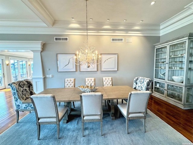 dining space with visible vents, crown molding, and wood finished floors