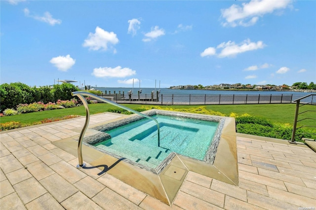 view of pool featuring a water view, a lawn, and fence