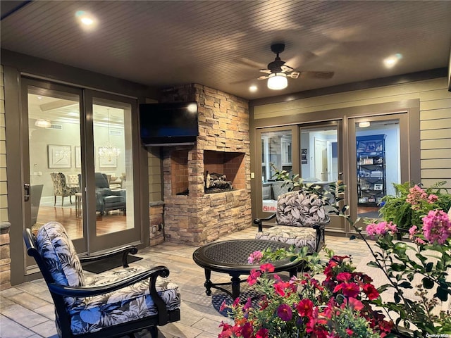 view of patio / terrace featuring a fireplace and ceiling fan