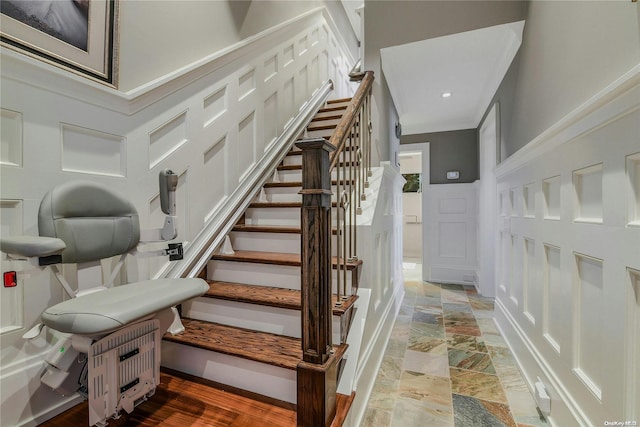 stairway with stone finish flooring and a decorative wall