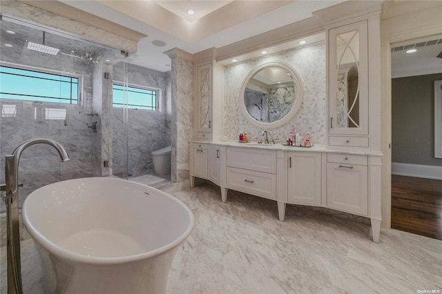 full bathroom featuring a freestanding tub, toilet, vanity, baseboards, and marble finish floor