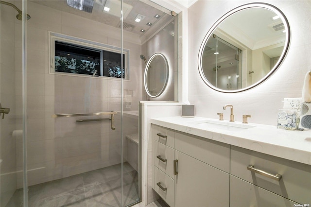 bathroom with a stall shower, tile walls, and vanity