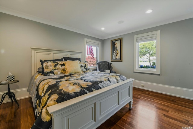 bedroom with dark wood-style floors, crown molding, and baseboards