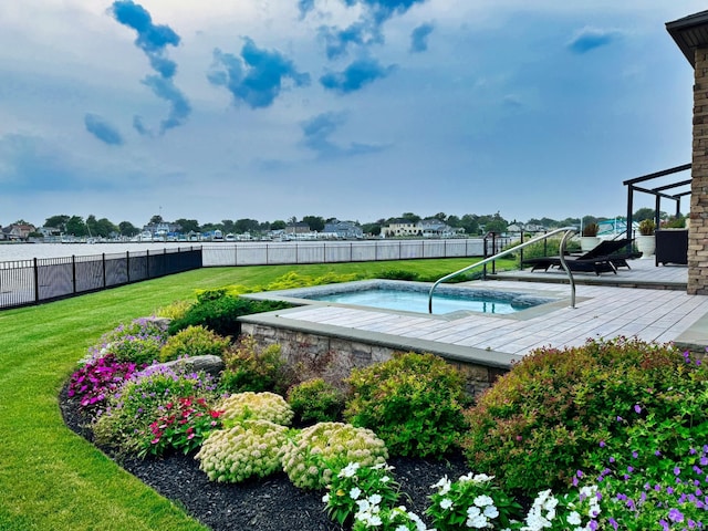 view of pool with a wooden deck, a yard, fence, and a fenced in pool