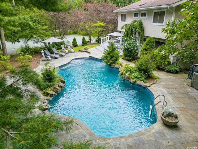 view of swimming pool featuring a patio area