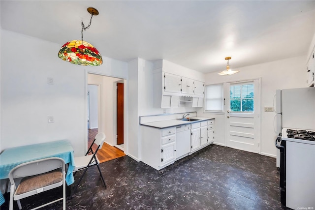 kitchen with white appliances, decorative light fixtures, white cabinetry, and sink