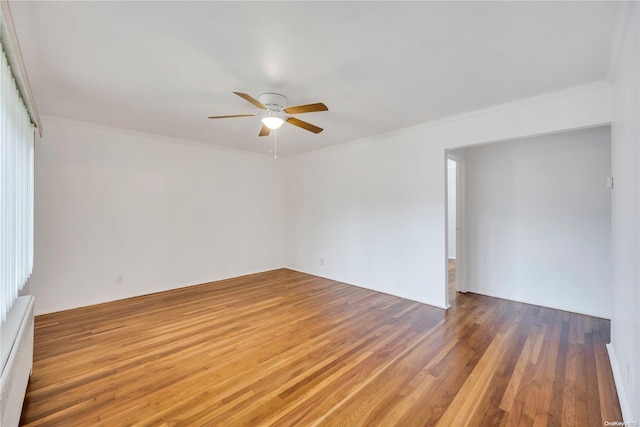 unfurnished room featuring dark hardwood / wood-style floors, ceiling fan, crown molding, and a baseboard heating unit