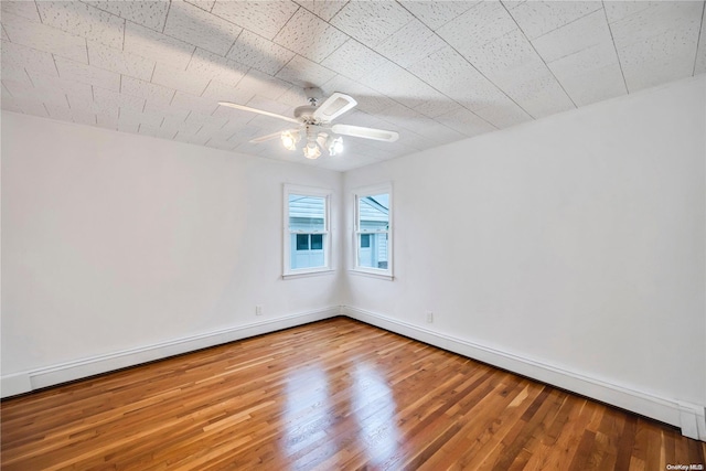 unfurnished room featuring hardwood / wood-style floors and ceiling fan