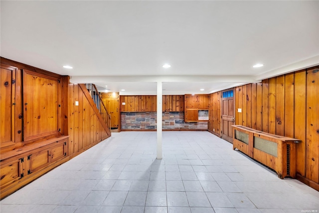 basement featuring wood walls