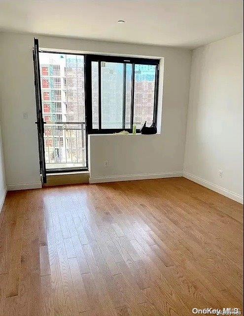 spare room featuring hardwood / wood-style floors