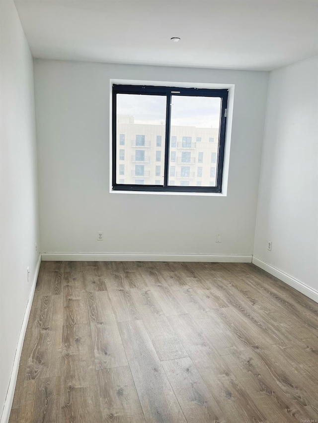 empty room with light hardwood / wood-style flooring