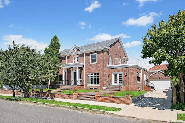 65 W Beech St, Long Beach, NY 11561 - colonial home featuring brick siding, a balcony, an outdoor structure, a garage, and concrete driveway