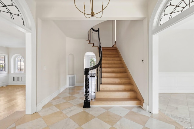 staircase featuring an inviting chandelier