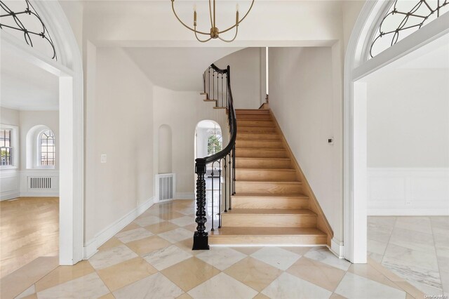 65 W Beech St, Long Beach, NY 11561 - stairs featuring a chandelier and a towering ceiling