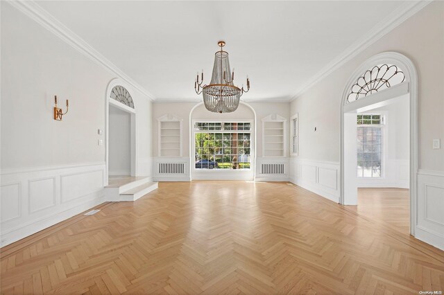 65 W Beech St, Long Beach, NY 11561 - empty room with a chandelier, built in features, wainscoting, crown molding, and radiator heating unit