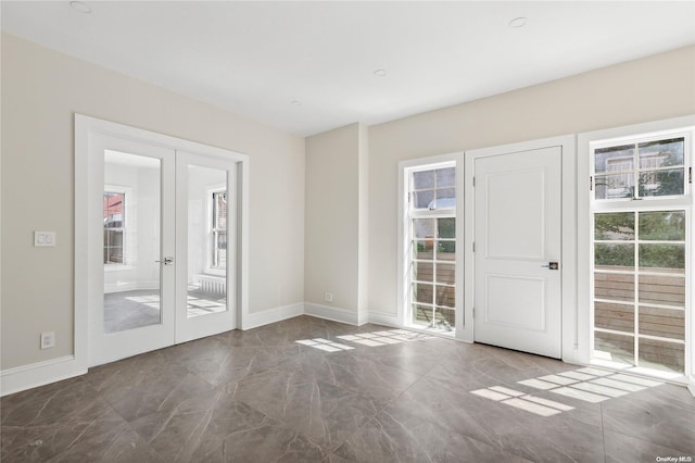 empty room with plenty of natural light and french doors