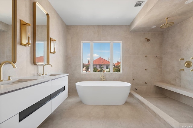 bathroom with concrete floors, vanity, and independent shower and bath