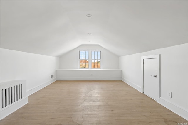 bonus room featuring light hardwood / wood-style flooring and lofted ceiling