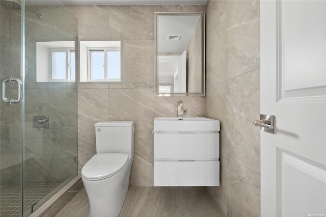 bathroom with toilet, a shower with door, vanity, tile walls, and hardwood / wood-style flooring