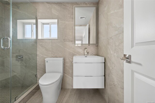 65 W Beech St, Long Beach, NY 11561 - full bathroom with tile walls, vanity, a shower stall, and toilet