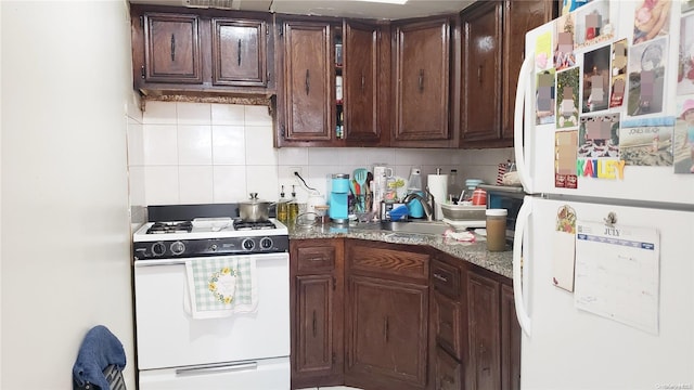 kitchen featuring tasteful backsplash, dark brown cabinets, sink, and white appliances