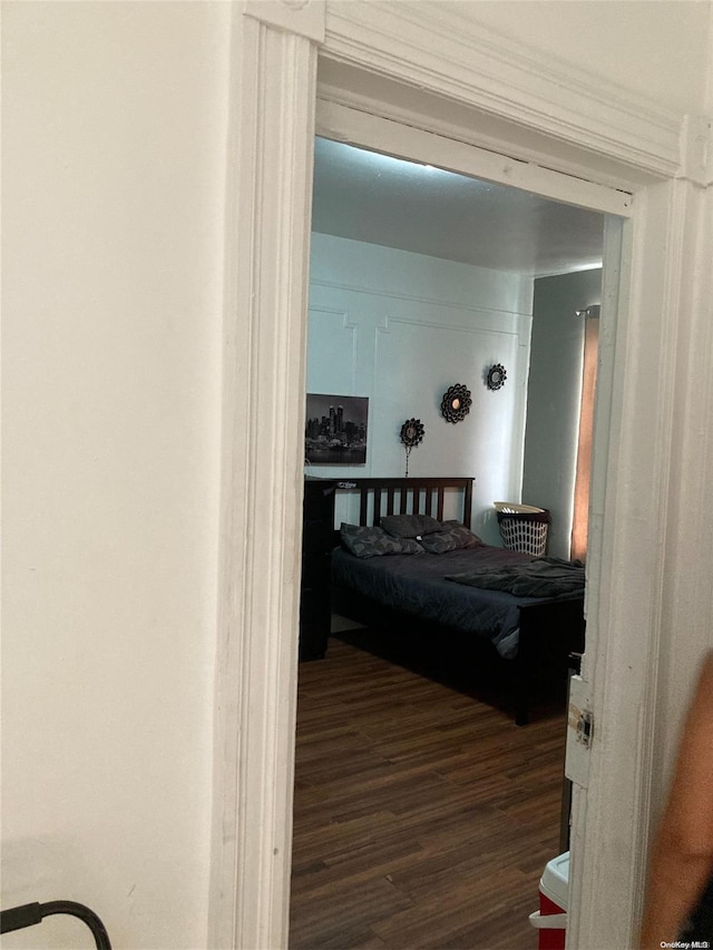 bedroom with dark hardwood / wood-style flooring