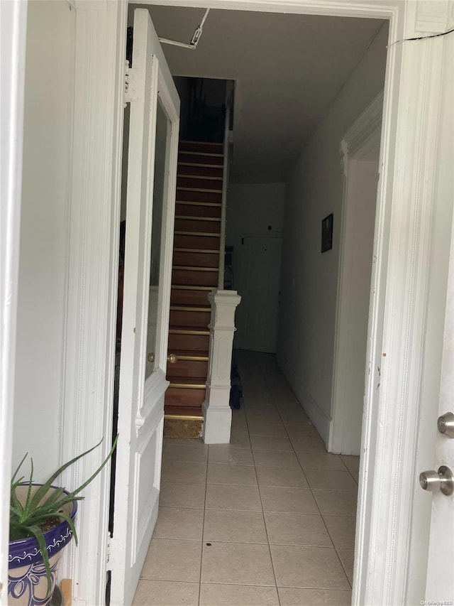 hallway featuring light tile patterned flooring