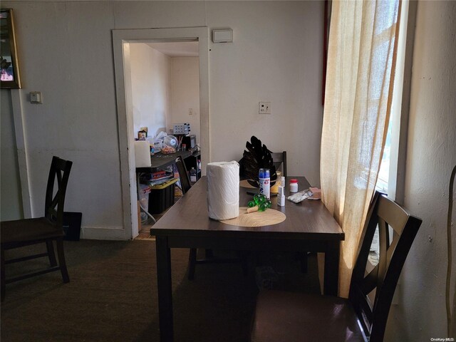 dining room with dark colored carpet