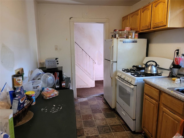 kitchen with sink and white gas range oven