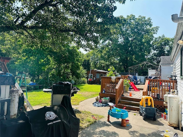 view of yard featuring a storage shed and a deck