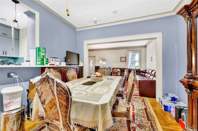 dining space featuring light parquet floors