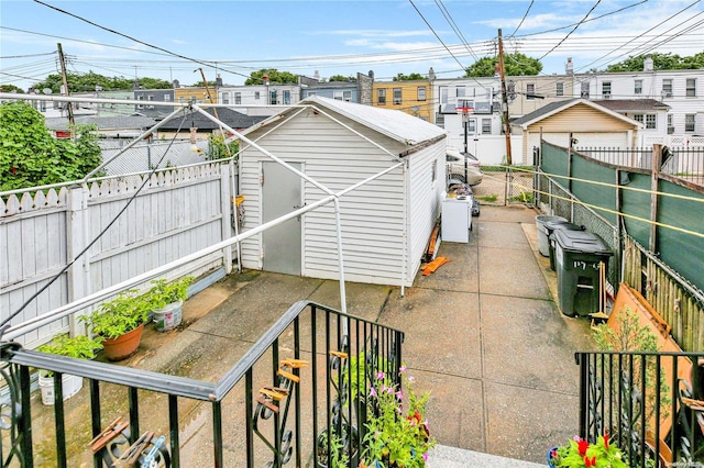 view of patio with a storage shed