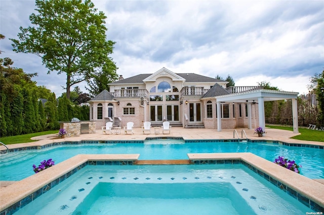 view of swimming pool featuring an in ground hot tub, area for grilling, and a patio area