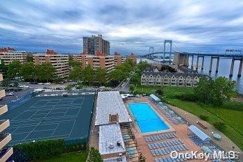 view of pool featuring tennis court