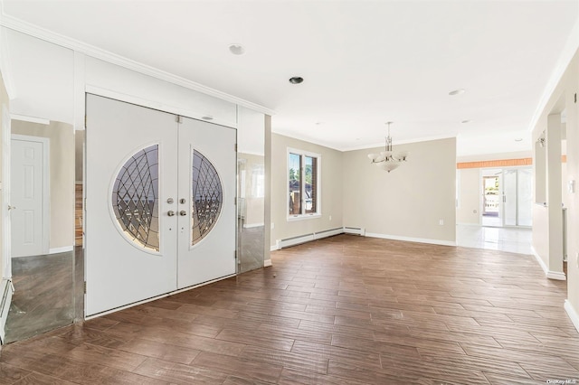 entrance foyer with dark hardwood / wood-style floors, french doors, a wealth of natural light, and a baseboard radiator