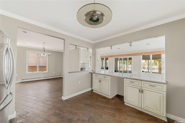 kitchen featuring stainless steel fridge, dark hardwood / wood-style flooring, light stone counters, ornamental molding, and a baseboard radiator