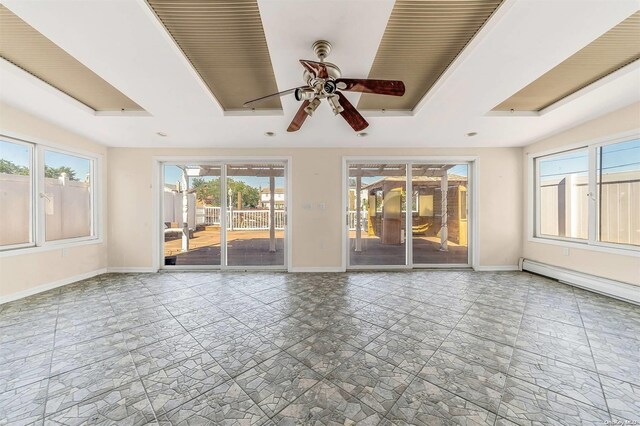 interior space featuring baseboard heating, plenty of natural light, and ceiling fan