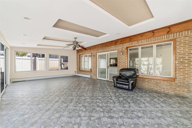 interior space with ceiling fan and a baseboard heating unit