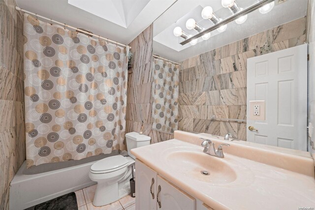 full bathroom with tile patterned flooring, vanity, toilet, and shower / bathtub combination with curtain