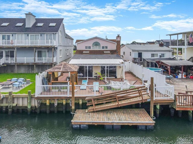 rear view of house with a deck with water view