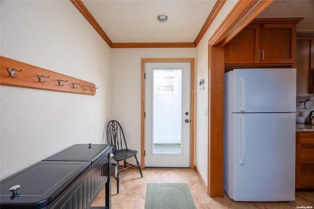 kitchen featuring white fridge and ornamental molding