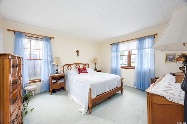 bedroom with light carpet and ornamental molding