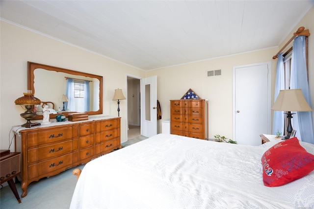 bedroom with light colored carpet and ornamental molding