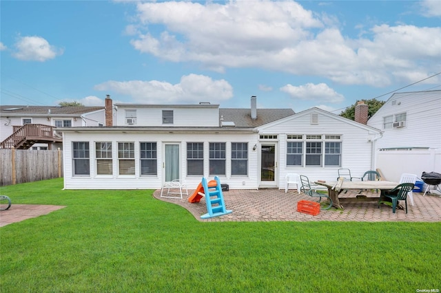 back of house with a yard and a patio area