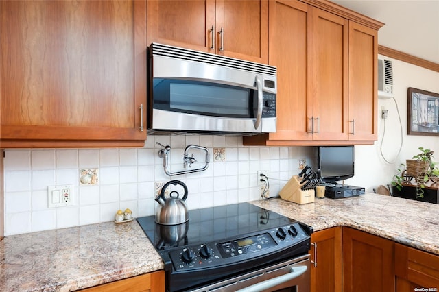 kitchen featuring light stone countertops, appliances with stainless steel finishes, and decorative backsplash