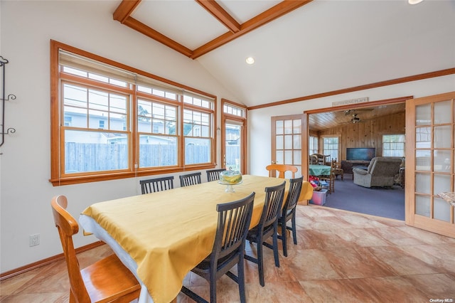 dining room featuring french doors and lofted ceiling with beams